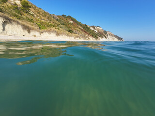 Panoramic view of the beach of Mezzavalle unique bay in Conero natural park dramatic coast headland rock cliff adriatic sea Italy turquoise transparent water