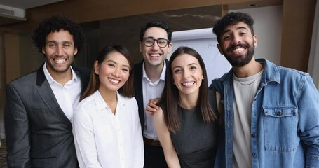 Wall Mural - Cheerful multiethnic business team of excited colleagues enjoying win, group achievement, teamwork success, showing winner yes hand, looking at camera with toothy smile