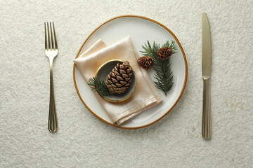 Sticker - Christmas table setting with plate, bowl, cutlery, fir branches and cones, flat lay