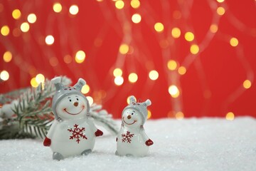 Poster - Cute decorative snowmen on artificial snow, space for text