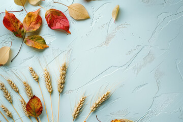 Wall Mural - Autumn background with colored leaves and wheat on white background, in a top view. Space for text. 