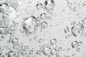 Wall Mural - The image is of a clear liquid with many small bubbles floating in it