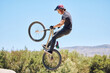 © Michael Cunningham/peopleimages.com - Extreme sports, jump and man on bicycle for competition, workout and exercise in countryside. Fitness, cycling and person with mountain bike in air for adventure, training or adrenaline on dirt trail