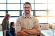 © peopleimages.com - Portrait, smile and business man with arms crossed for coworking, pride or opportunity. Face, confidence or manager, entrepreneur or creative editor with glasses in startup for leadership experience