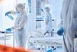 © Azee Jacobs/peopleimages.com - Hospital, contamination and people cleaning with disinfection for biohazard, safety or protocol. Red tape, medical and work with PPE in ward for healthcare compliance, sanitation or infection control