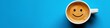 © keks20034 - A coffee cup with a smiley face on a blue background embodies the concept of a happy morning