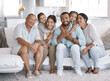 © peopleimages.com - Hug, portrait and smile with big family on sofa in living room of home together for bonding or visit. Happy, love or relax with senior people, parents and sibling children in apartment on weekend