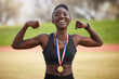 © Nina2024/peopleimages.com - Black woman, smile and celebration with medal as flex for winner, competition and sports achievement outdoor. Athlete, portrait and success with professional running, award and podium performance