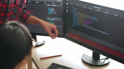 Slow motion back end or software developer manager supervising his team on new application program development on debugging and solving complex code algorithms on monitor. Burgeoning