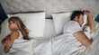 © Flashizzle/peopleimages.com - Frustrated couple, bed and above with argument for fight, conflict or cheating affair at home. Top view, man and woman with seperation for disagreement, toxic marriage or bad relationship in bedroom