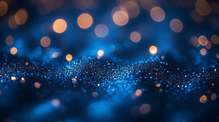 Abstract blue and gold bokeh background with blurred lights.