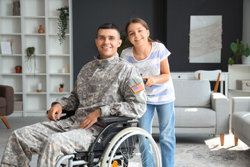 Poster - Soldier in wheelchair with his little daughter at home. Veterans Day celebration