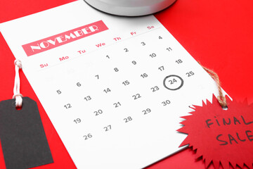 Poster - Calendar with date 24 NOVEMBER and discount tag on red background, closeup. Black Friday sale