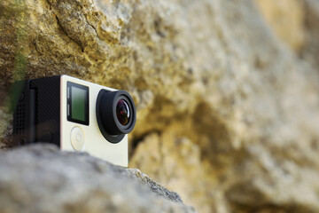 Poster - Modern action camera on stone, closeup. Space for text