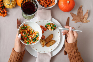 Wall Mural - Woman having Thanksgiving dinner at table, top view