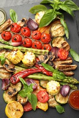 Wall Mural - Delicious grilled vegetables with spices on grey table, flat lay