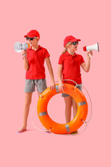 Wall Mural - Happy little children lifeguards with ring buoy and megaphones on pink background