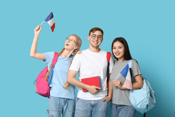 Wall Mural - Group of students with French flags on blue background