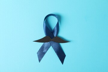 Poster - Dark blue ribbon and fake mustache on color background, top view. Prostate cancer awareness