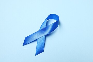 Wall Mural - Blue ribbon on light background. Prostate cancer awareness