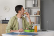 © Pixel-Shot - Young man having lunch at home
