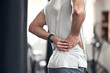 © Van Wyk/peopleimages.com - Hip pain, man and fitness injury at gym for boxing, sport and training with accident at health center. Wellness, hands and exercise of an athlete with hurt joint and scoliosis concern of spine