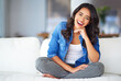 © C.Arcurs/peopleimages.com - Laugh, happy and smile with woman in lounge for satisfaction, relaxing and weekend. Funny joke, peace and confident with portrait of female student on sofa at home for calm, carefree living room rest