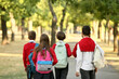 © Pixel-Shot - Group of pupils going to school outdoors, back view