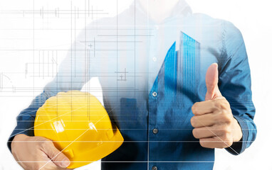 A man stands holding a yellow safety helmet, showing his thoroughness in preventing accidents at work.