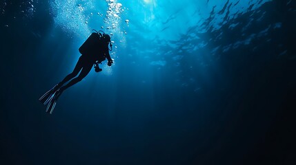 Wall Mural - Silhouette of a Diver Ascending in the Deep Blue