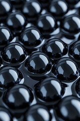 Poster - Macro closeup of glossy black spheres creating abstract pattern. Reflective surface texture, geometric symmetry, and modern design concept.