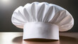 © hide - クラシックなシェフの帽子がテーブルの上に置かれているシーンを描いています。帽子は白く、上部が膨らんだ形状で、プロのシェフや料理人を象徴するアイテムです。背景はシンプルで、帽子自体が強調されており、料理やプロフェッショナリズムを連想させるデザインです。generative AI
