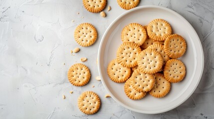 Sandwich crackers filled with peanut butter flavored cream in white plate.