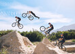 © Michael Cunningham/peopleimages.com - Jump, cycling and person on dirt bicycle with adventure, adrenaline and speed in stunt competition, Extreme sport, trick and athlete on bike for challenge, talent or energy on action course in nature