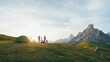 © Martí Rosselló - Group Camping at Sunset with Majestic Mountain Views, A group of friends enjoying a camping trip at sunset, surrounded by stunning mountain scenery and a golden sky.