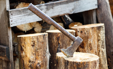 An axe stuck into a log. Close-up