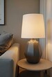 © Giuseppe Cammino - Close up of lamp on side table near sofa. Home interior design of modern living room