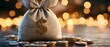 © Siripong - A close-up of a money bag filled with coins, symbolizing wealth and financial success against a blurred, sparkling background.