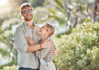 Canvas Print - Couple, hug and laughing with love in garden with care, bonding and outdoor in spring for connection. People, man and woman in embrace, funny joke or smile in backyard for memory by trees in Croatia