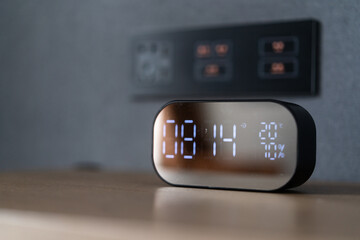 clock with digital display on side table 