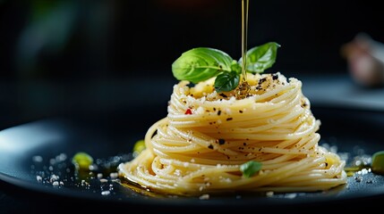 Wall Mural - A stylishly arranged plate of Italian spaghetti with green bell peppers and a drizzle of olive oil, contrasted against a deep black backdrop.