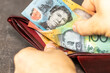 © Rochu_2008 - hands opening wallet with Australian money, financial concept. Australia dollar
