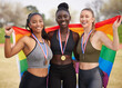 © Nina2024/peopleimages.com - Athlete, together and medal in portrait with flag, rainbow or support for LGBTQ, human rights or equality. Women, people and champion with team, sign or solidarity for win at global sport competition