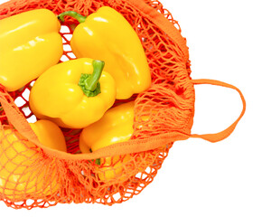 Wall Mural - Yellow bell peppers in reusable orange mesh bags on transparent background, showcasing fresh, seasonal produce. Perfect for promoting sustainable shopping, healthy eating, and eco-conscious living