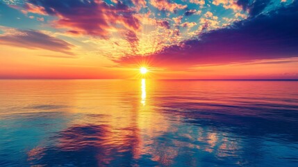 Panoramic view of a tranquil seaside sunset, with the sun setting behind a distant horizon and casting a colorful reflection across the calm sea.