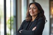© Dzikrul Husnani - Happy confident mature professional business woman standing at work in office arms crossed looking away, proud hispanic middle aged businesswoman leader executive thinking of future success , ai