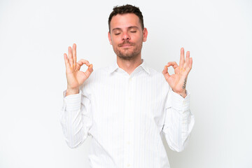 Young caucasian handsome man isolated on white background in zen pose