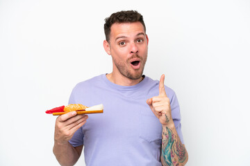 Young caucasian man holding sashimi isolated on white background intending to realizes the solution while lifting a finger up