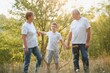 © Serhii - Grandfather grandmother and grandson having fun outdoors in park