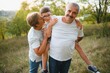 © Serhii - Grandparents and grandson together in autumn park